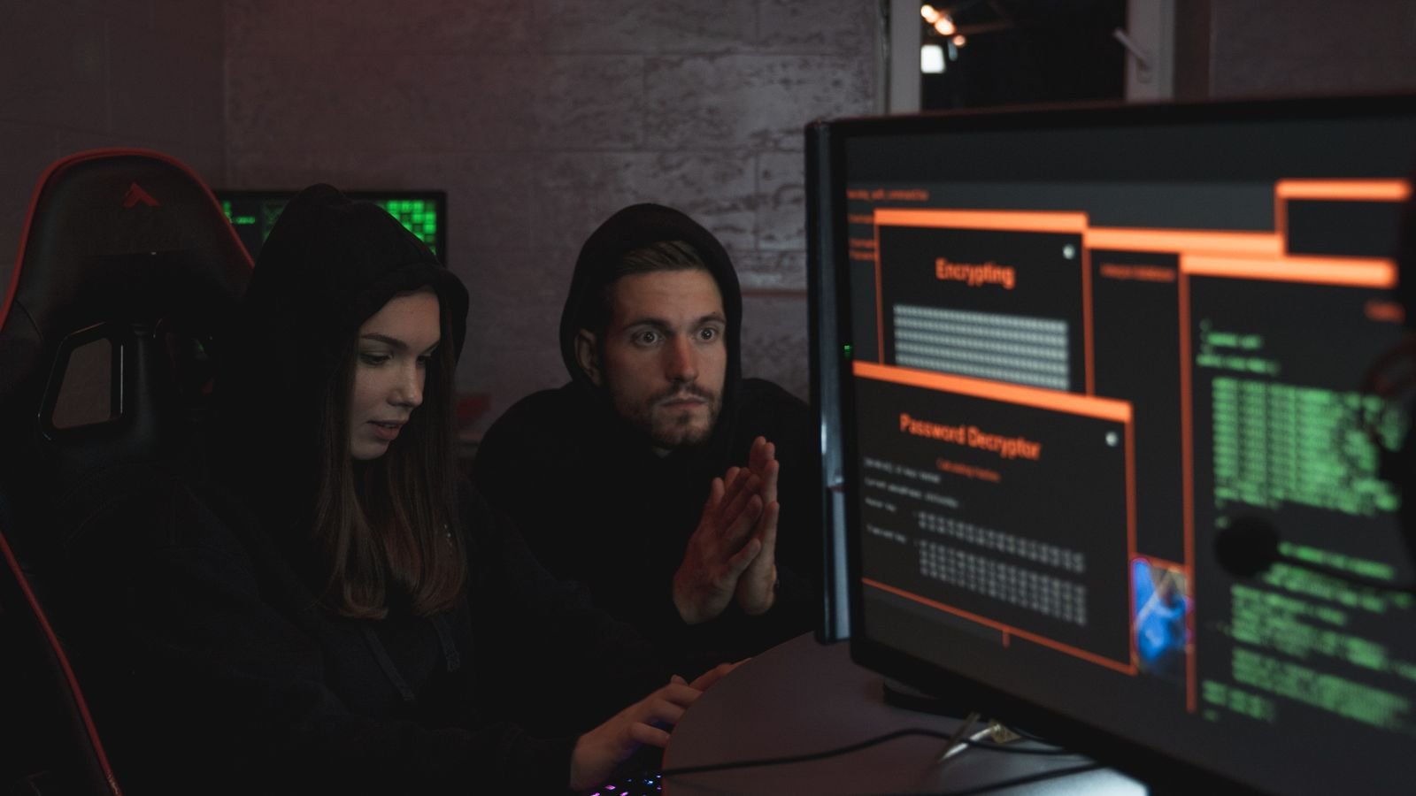 Cybersecurity analysts monitoring encrypted data and network activity on computer screens