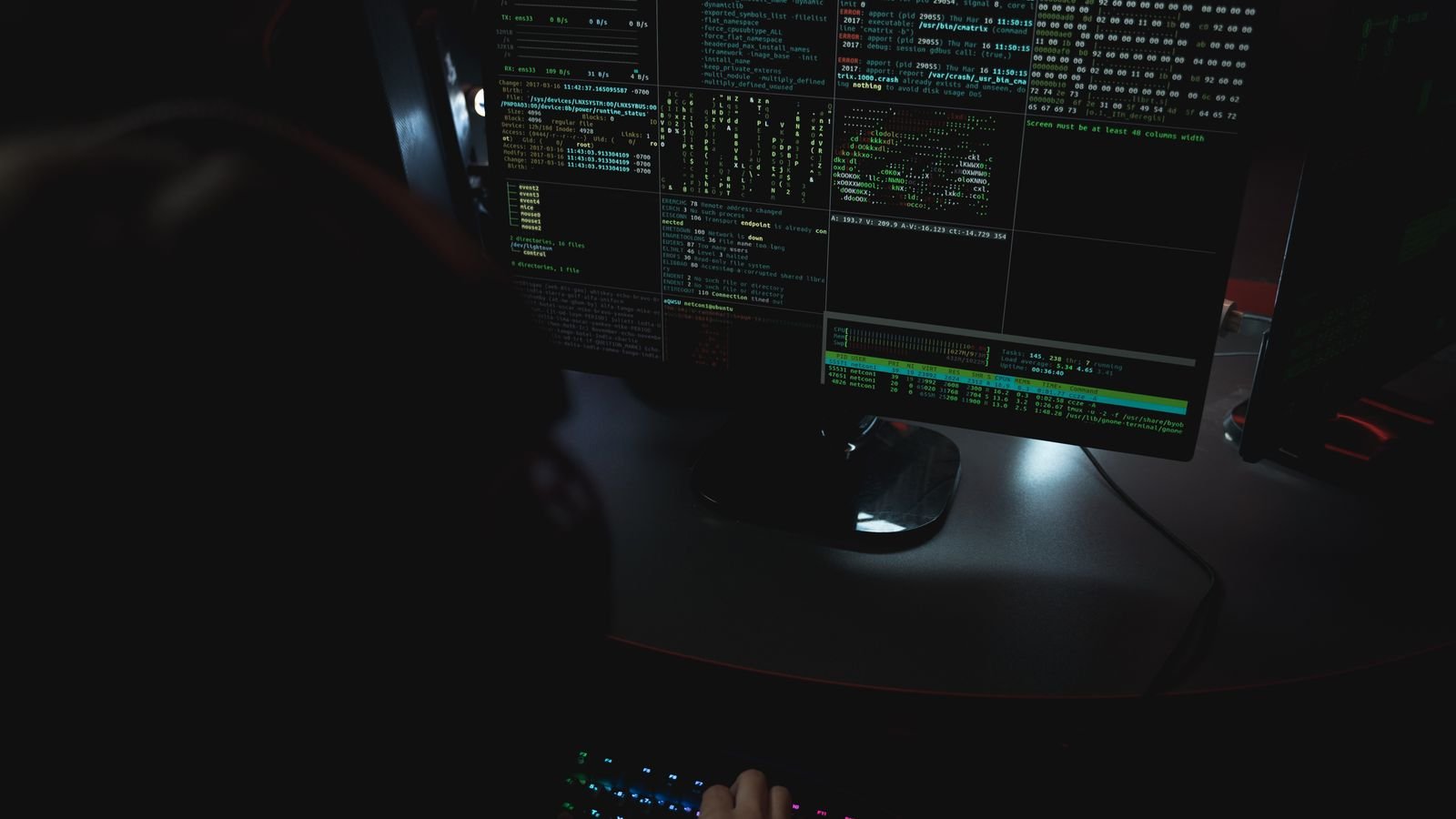 Digital forensic workstation with security code displayed across multiple monitors