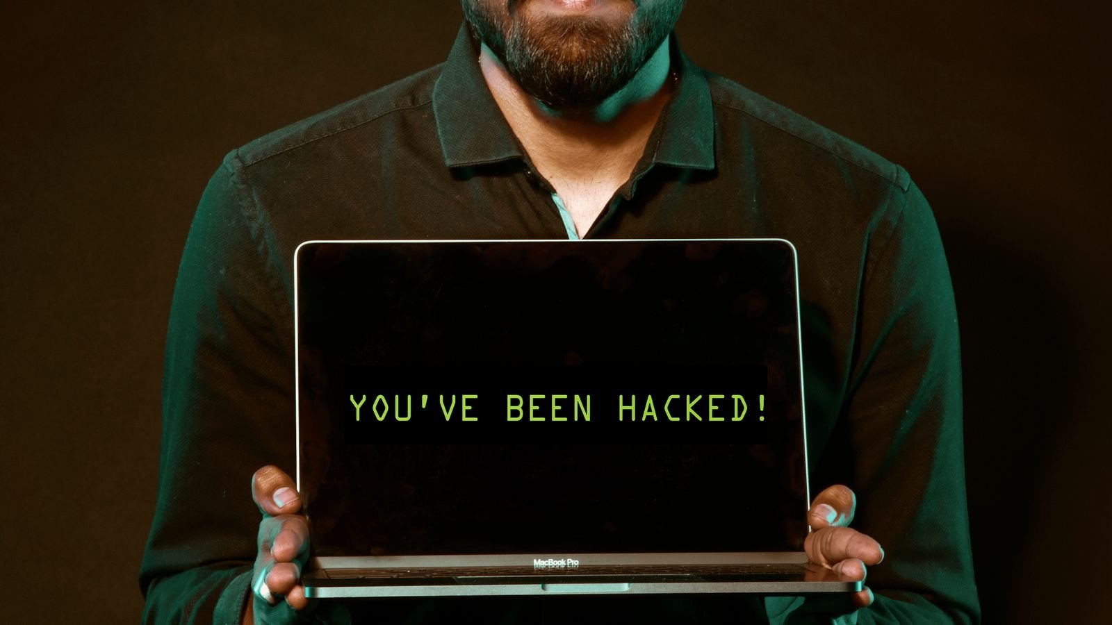 Laptop displaying a hacked-account warning during a cybersecurity incident