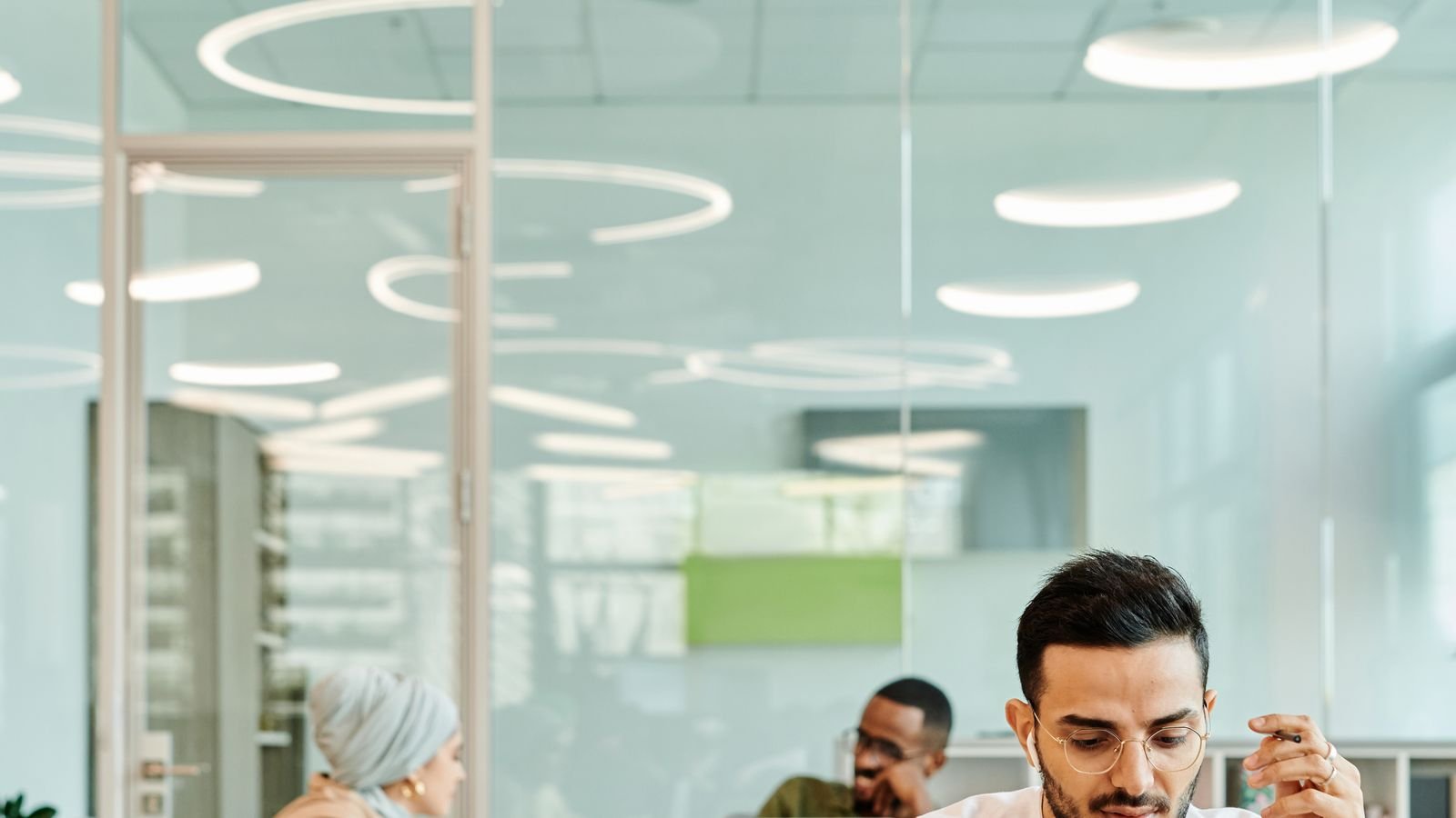 Professional team using laptops in a modern small-business office